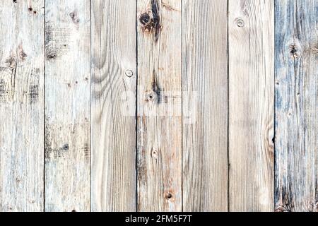 Texture of the planks of an old wooden table in antiqued light pastel colors. Vintage rustic wooden background. Carpentry. Stock Photo