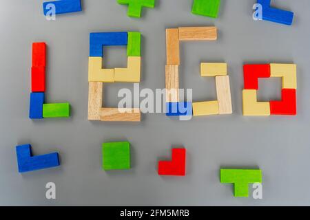 Wooden cube on the gray background. Multi-colored cubes on the table. Geometric shapes on a wooden background. Puzzle concept. High quality photo Stock Photo