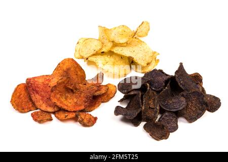 Three varieties of kettle-cooked potato chips, made of yellow, red and blue potatoes, isolated on white background Stock Photo