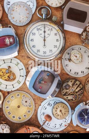 Collection of vintage rusty watches and parts on a brown old wooden background Stock Photo