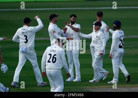 6th May 2021; Emirates Old Trafford, Manchester, Lancashire, England; County Championship Cricket, Lancashire versus Glamorgan, Day 1; Saqib Mahmood of Lancashire celebrates with his team mates after bowling Joe Cooke of Glamorgan Credit: Action Plus Sports Images/Alamy Live News Stock Photo