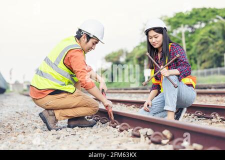 Team engineer holding wrench for repair working on train site, safety, civil, workers Stock Photo