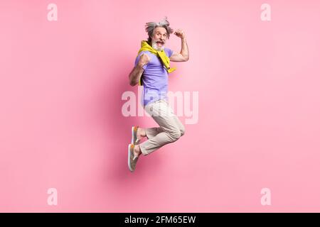 Full length profile side photo of aged man jump up show muscles sportive isolated over pastel color background Stock Photo