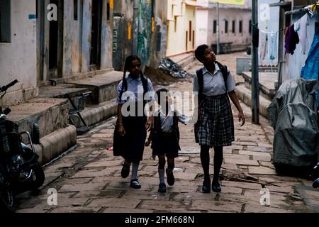 children going hands by hands to their school in Varanasi, Uttar Pradesh, India Stock Photo