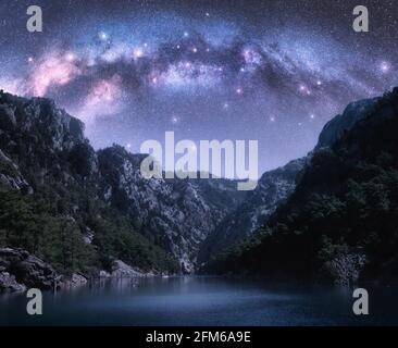 Arched Milky Way and stars over beautiful mountains and sea Stock Photo