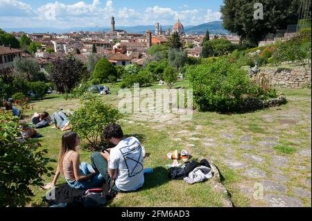 People at the Giardino delle Rose, sitting on the lawn, on a warm spring day.. Stock Photo