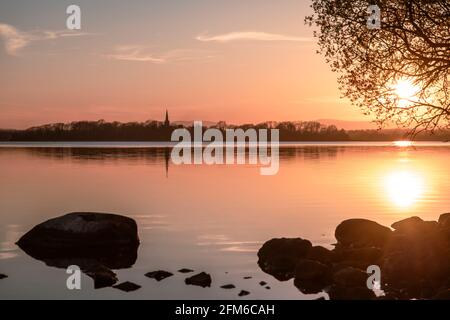 St Patrick's Church and spire on Lough Beg viewed from the woods on the east side in Antrim Stock Photo