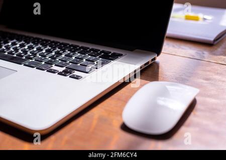 notebook with a mouse on a table Stock Photo