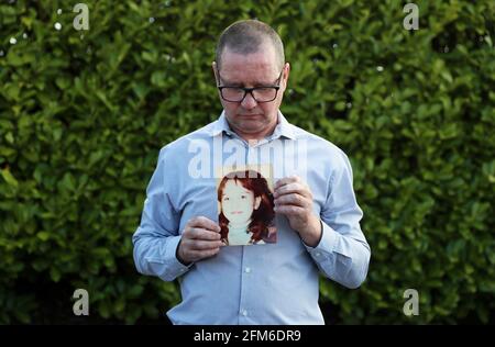 Mark Kelly holds a photograph of his his 12 year old sister Carol-Ann who he saw die after being struck by a plastic bullet in Belfast in 1981. Mr. Kelly has said the British Government cannot be allowed to block future legal cases as bereaved families in Northern Ireland pursue justice for their loved ones. He was speaking following reports that the UK Government is set to introduce a statute of limitations on prosecutions for conflict crimes that occurred pre-1998. Picture date: Thursday May 6, 2021. See PA story ULSTER TroublesVictims. Stock Photo