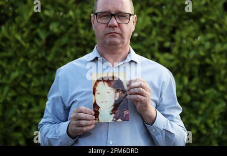 Mark Kelly holds a photograph of his his 12 year old sister Carol-Ann who he saw die after being struck by a plastic bullet in Belfast in 1981. Mr. Kelly has said the British Government cannot be allowed to block future legal cases as bereaved families in Northern Ireland pursue justice for their loved ones. He was speaking following reports that the UK Government is set to introduce a statute of limitations on prosecutions for conflict crimes that occurred pre-1998. Picture date: Thursday May 6, 2021. See PA story ULSTER TroublesVictims. Stock Photo