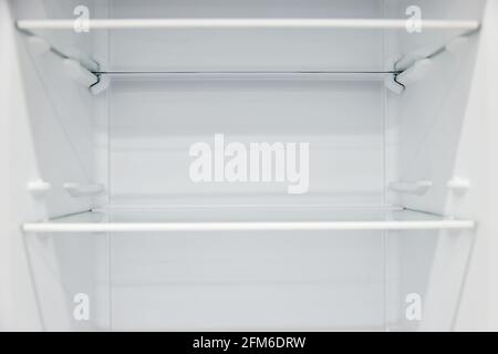 An empty refrigerator. Inside an empty, clean refrigerator, a refrigerator compartment after defrosting. Stock Photo