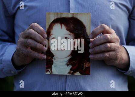 Mark Kelly holds a photograph of his his 12 year old sister Carol-Ann who he saw die after being struck by a plastic bullet in Belfast in 1981. Mr. Kelly has said the British Government cannot be allowed to block future legal cases as bereaved families in Northern Ireland pursue justice for their loved ones. He was speaking following reports that the UK Government is set to introduce a statute of limitations on prosecutions for conflict crimes that occurred pre-1998. Picture date: Thursday May 6, 2021. See PA story ULSTER TroublesVictims. Stock Photo