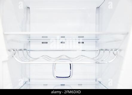 An empty refrigerator. Inside an empty, clean refrigerator, a refrigerator compartment after defrosting. Stock Photo