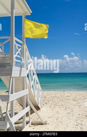 Lifeguard tower with yellow flag on a tropical beach Stock Photo