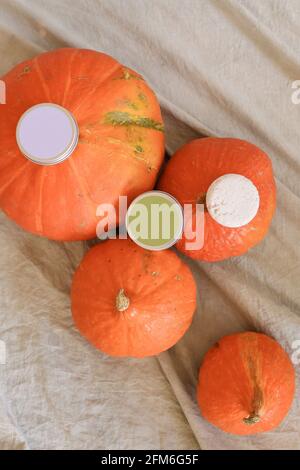 White soap in round aluminum metal tin on neutral background. Natural cosmetic product. Face and body skin care, cosmetic products with pumpkin Stock Photo