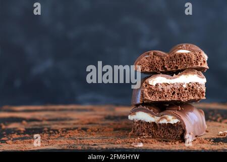 Stack of milk porous or aerated chocolate close-up on dark background Stock Photo