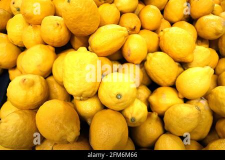 Still life with crop of many ripe yellow lemons fruits as background top view close-up Stock Photo