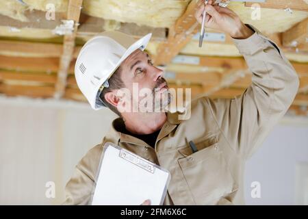 technician man hand checking the ceiling Stock Photo