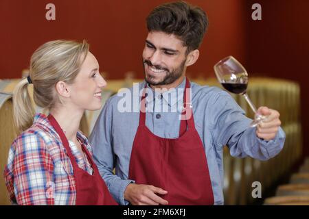 artisan wine production workers holding a glass of red wine Stock Photo