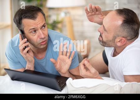 upset couple is arguing on the bed Stock Photo