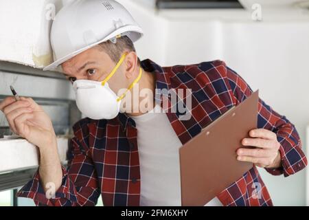construction worker checking thermally insulating walls Stock Photo