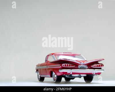 Johnny Lightning 1/64 scale red 1959 Chevrolet Impala diecast on a white background Stock Photo