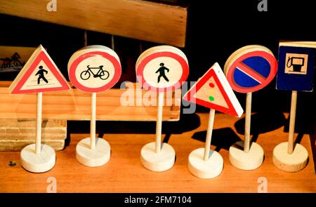 Wooden miniature road signs on a shelf in Spain Stock Photo