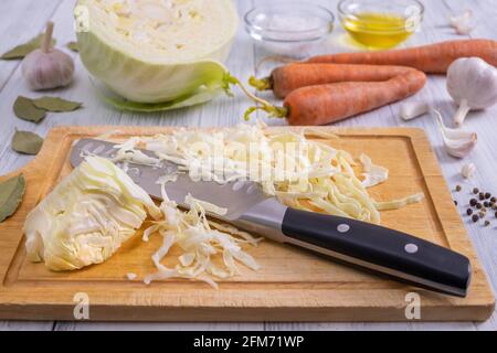 Kitchen workspace with the process of shredding white cabbage Stock Photo