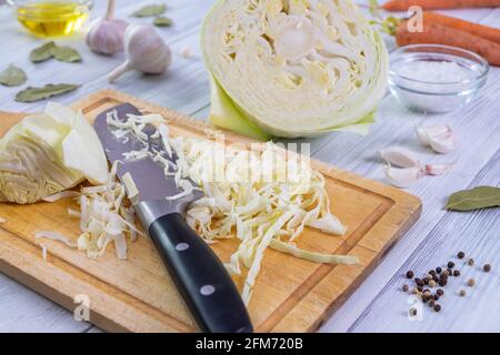 Kitchen workspace with the process of shredding white cabbage Stock Photo