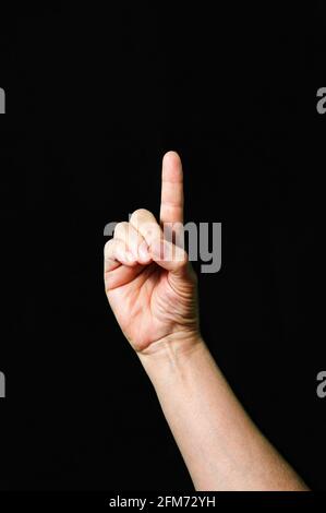 Hand making and showing Letter D International sign language dark background Stock Photo