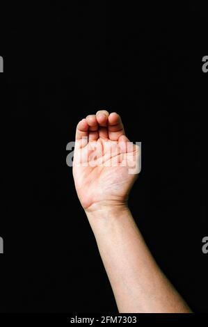 Hand making and showing Letter C International sign language dark background Stock Photo