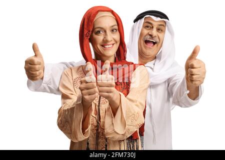 Young muslim woman and a mature arab man gesturing thumbs up isolated on white background Stock Photo