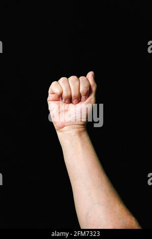 Hand making and showing Letter A International sign language dark background Stock Photo