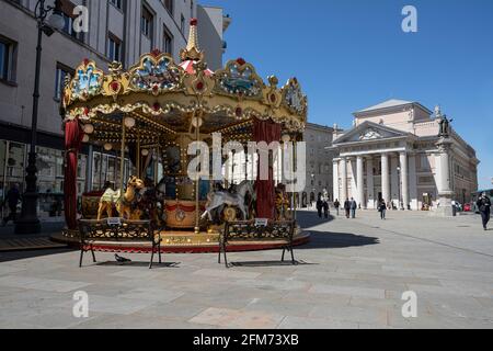 Trieste, Italy. May 3, 2021.  An old carousel for children in piazza della Borsa Stock Photo