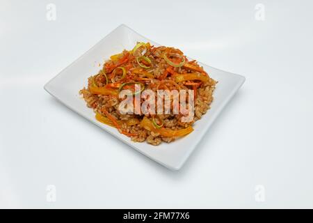 hot Italian macaroni in a disposable dish for food delivery, high-calorie fast food pasta on a white background Stock Photo