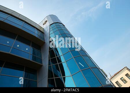 in the reflection of a glass window, a bakery clerk is mopping the floor with a MOP, disinfecting and cleaning the store to keep it clean during an ep Stock Photo