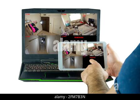 Viewing the home security camera from a computer and tablet at the same time Stock Photo