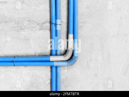 Plastic PVC pipe insulation on construction concrete home wall repair. Stock Photo