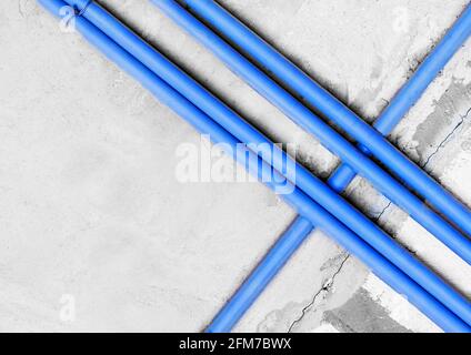 Plastic PVC pipe insulation on construction concrete home wall repair. Stock Photo