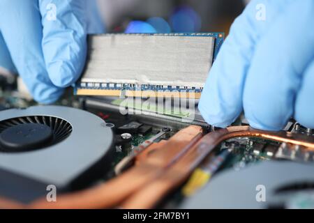 Replacing computer board in a laptop closeup Stock Photo