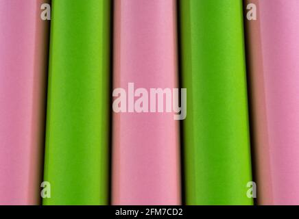Abstract colored macro background, created with green and pink paper rolls. Curved lines and shapes and soft vivid colors. Stock Photo