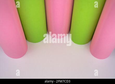 Abstract colored macro background, created with green and pink paper rolls. Curved lines and shapes and soft vivid colors. Stock Photo