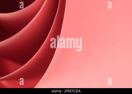 Abstract colored macro background, created with curved red paper sheets. Curved lines and shapes and soft vivid colors. Stock Photo