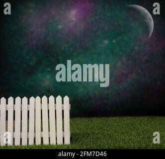 Blue wooden picket fence with blurred green background Stock Photo - Alamy