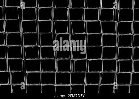 A pile of metal plates and square industrial pipes texture background. Building materials at the construction site Stock Photo