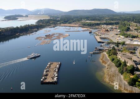 BC Ferry Kuper approaching Chemainus with the Western Forest Products Ltd. sawmill in Chemanius and the Crofton Paper Mill in the distance, Vancouver Stock Photo