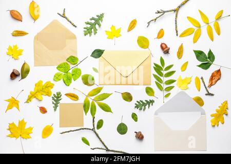 Envelopes with cards and autumn leaves on white background Stock Photo