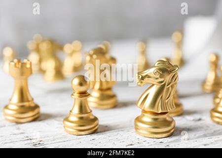 Chess figures on white wooden background Stock Photo