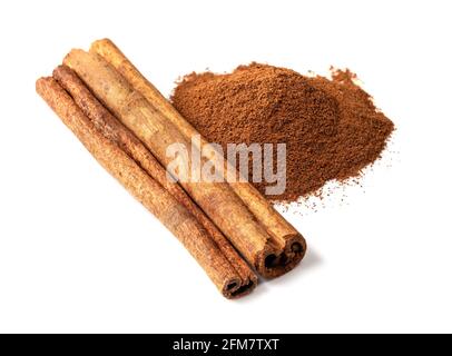 pile of cassia stick and cinnamon powder closeup on white background Stock Photo