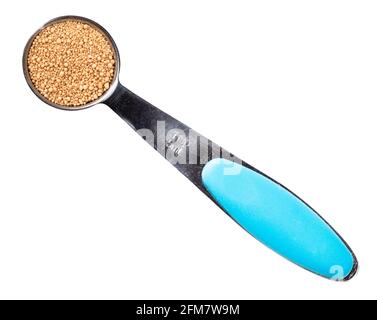 top view of granulated active dry yeast in measuring teaspoon cutout on white background Stock Photo